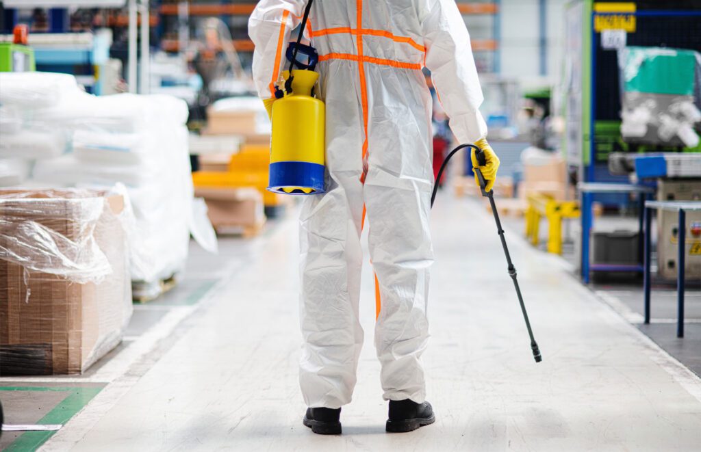 man worker with protective mask and suit disinfecting